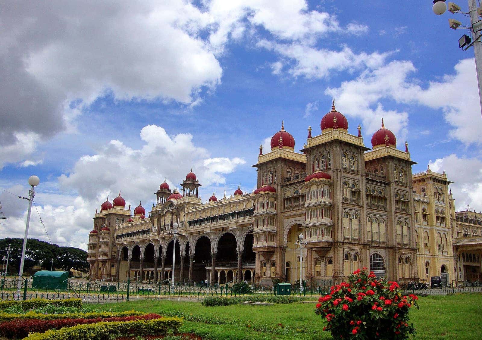 Mysuru Palace with its red domes under a bright blue sky