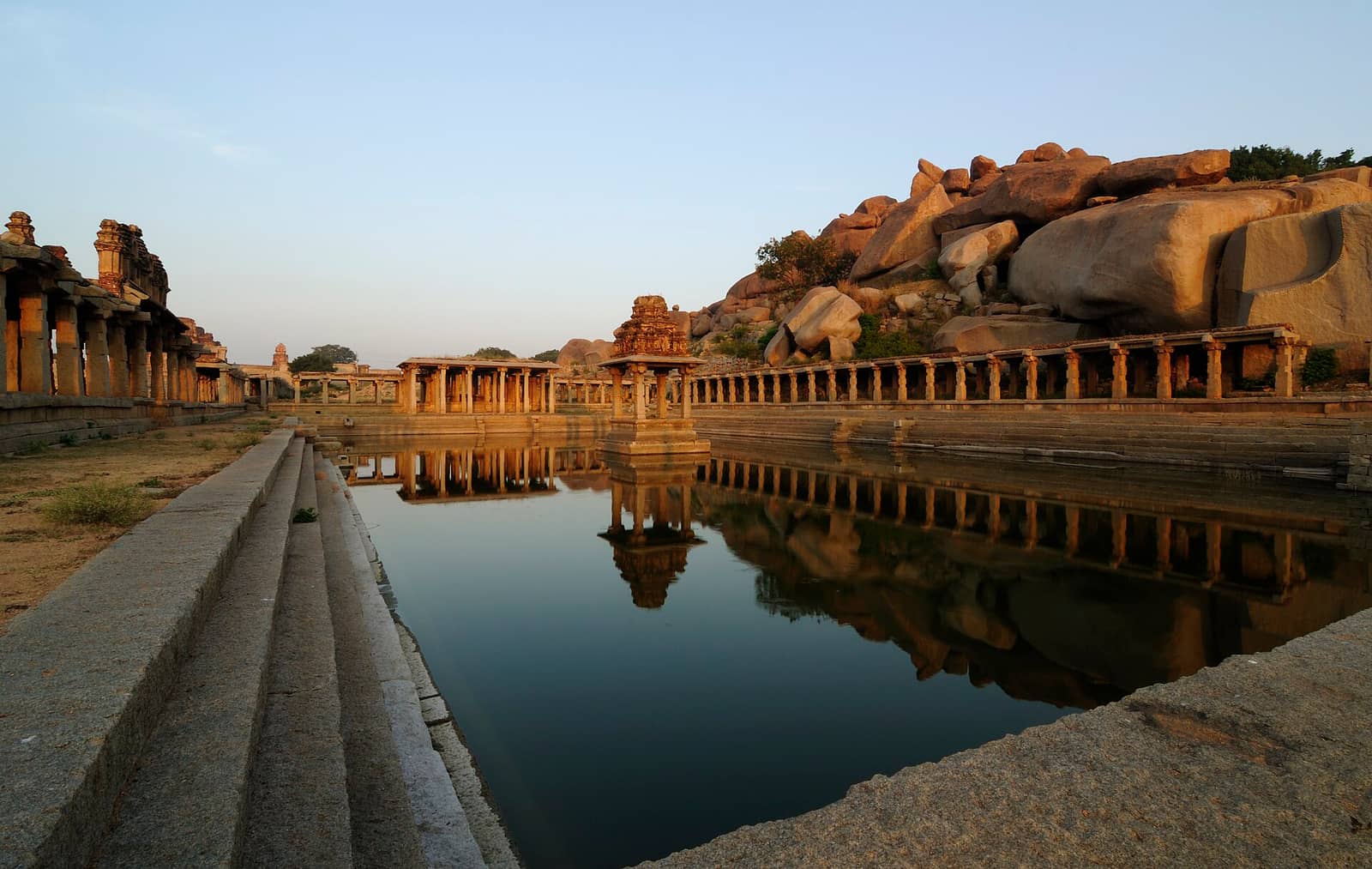 The stepped Krishna Pushkarani temple tank among the ruins of Hampi